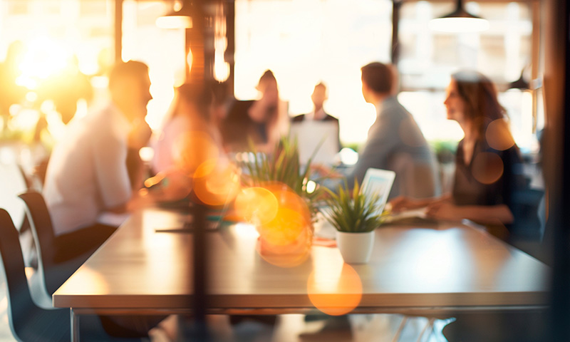 blurred image of business people sitting at tables