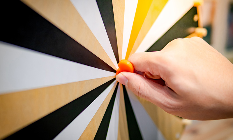 a hand spinning a prize wheel